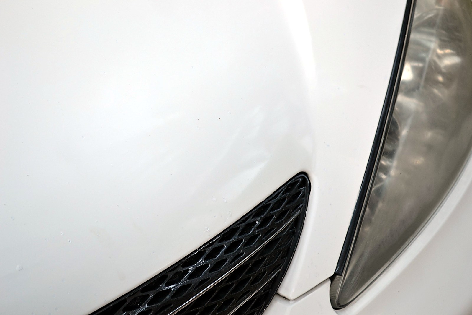 Before and after comparison of white Toyota hood repaired with Dr. ColorChip automotive paint chip repair kit, showing rock chips virtually eliminated.