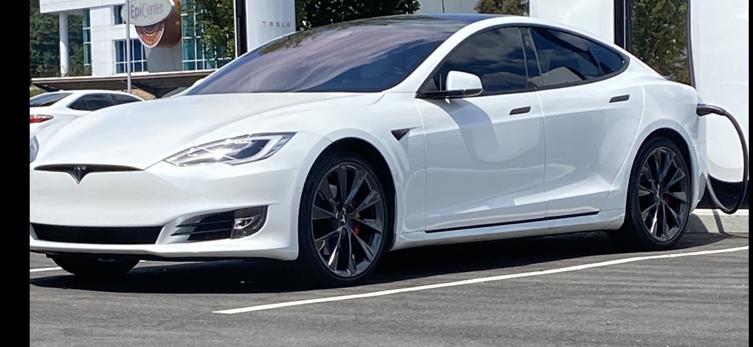 White Tesla with dark tinted side windows